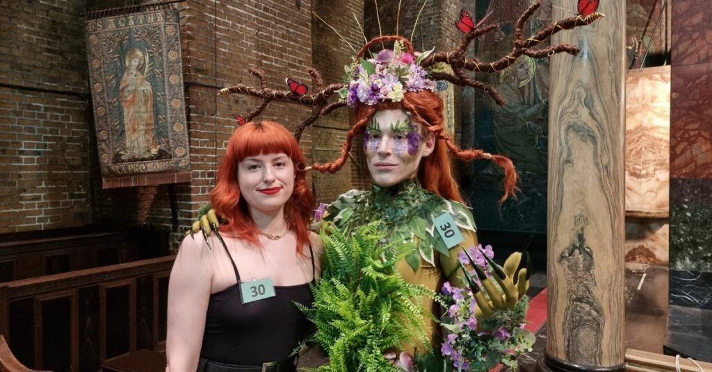 The winner Hannah stood with her model George, who is wearing a floral outfit with headpiece