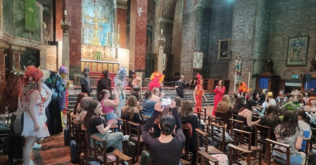 Students lining up in the Church to walk down the aisle and exhibit their designs to the crowd