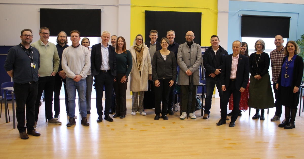 All the representatives of the different companies stood in the conference room for a photo