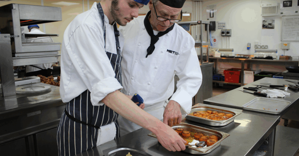 One of our level three students preparing savoury snacks with a lecturer
