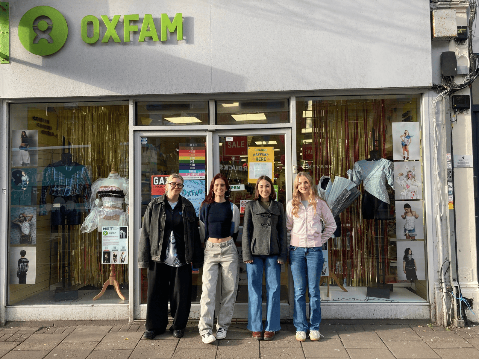 Some of the students from the project stood outside the Oxfam with their designs