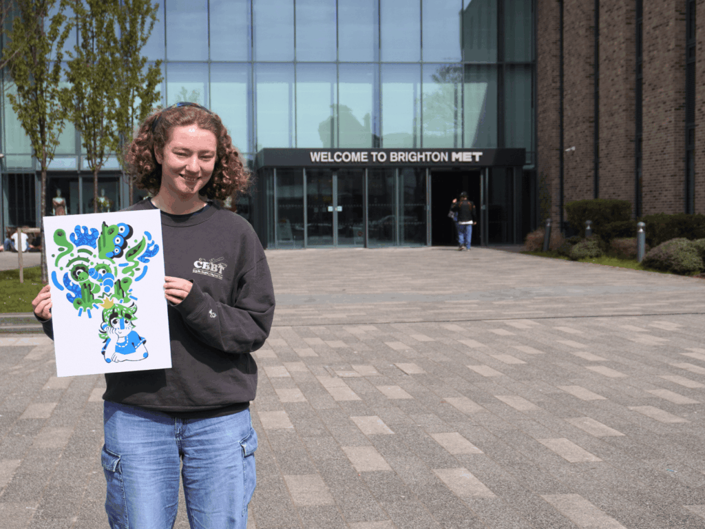 Annalisa holding her design stood outside the college